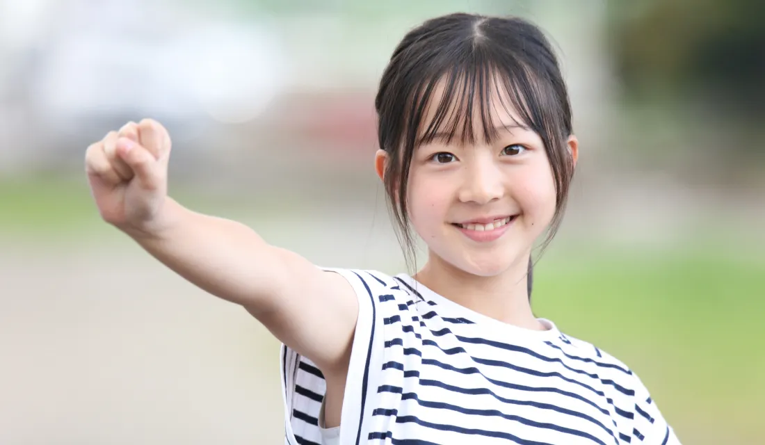 笑顔で手を上げる子ども